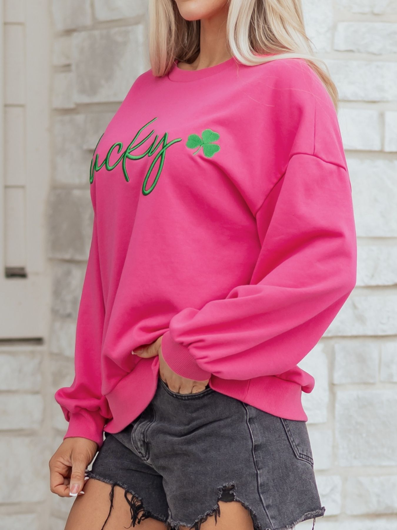 Pink crew neck cotton sweatshirt with green embroidered lucky clover detail