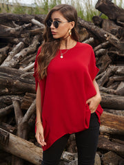 Scarlet red draped asymmetrical sleeve blouse with a relaxed fit and rounded neckline.