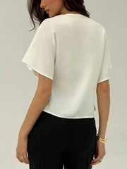 White button-down shirt with deep V-neck and short sleeves, cropped hem