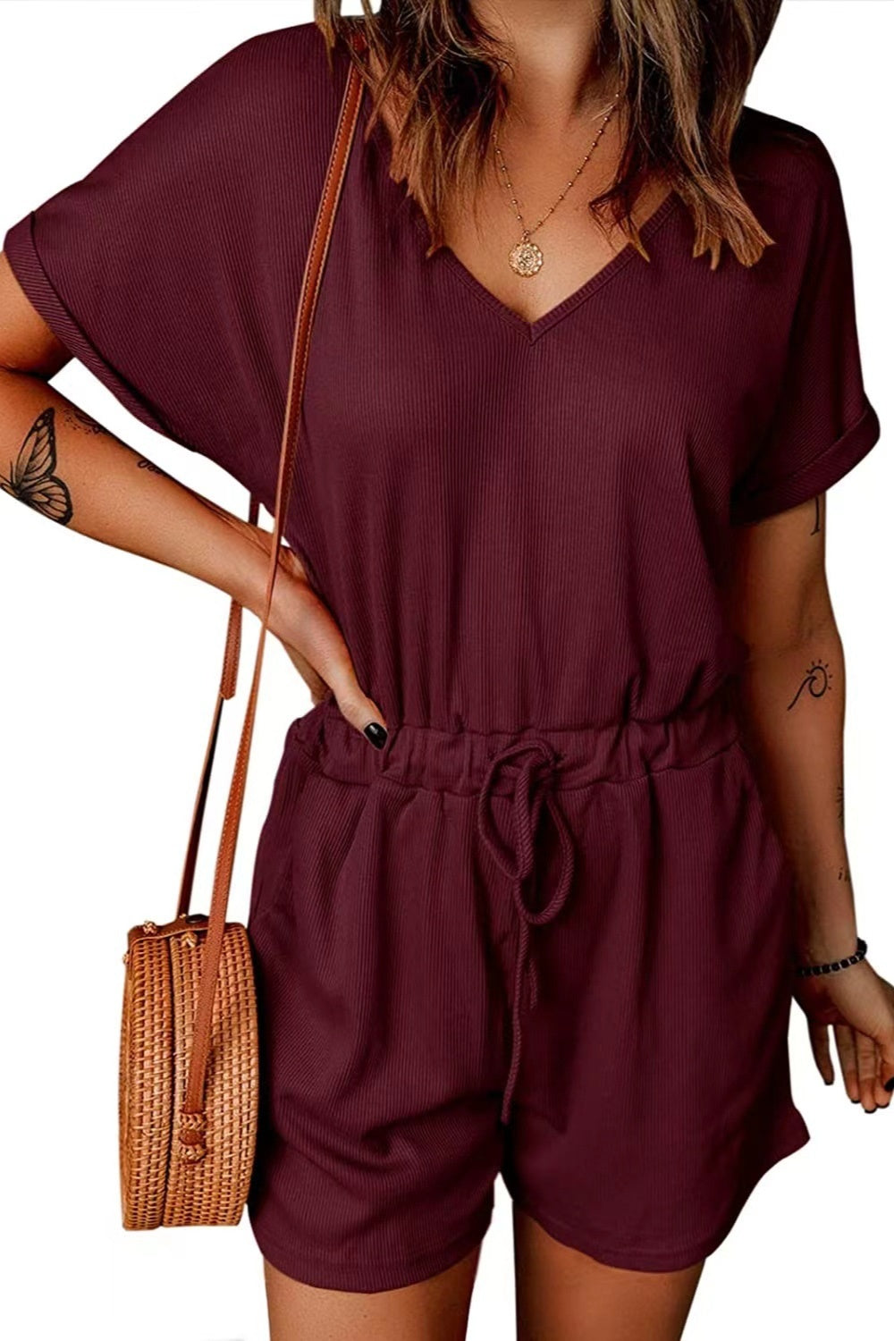 Burgundy ribbed V-neck romper with adjustable drawstring waist and cuffed short sleeves.