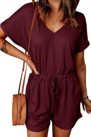 Burgundy ribbed V-neck romper with adjustable drawstring waist and cuffed short sleeves.