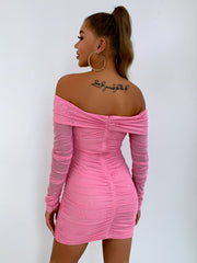 Pink ruched off-shoulder mini dress with glitter detail and long sheer sleeves.