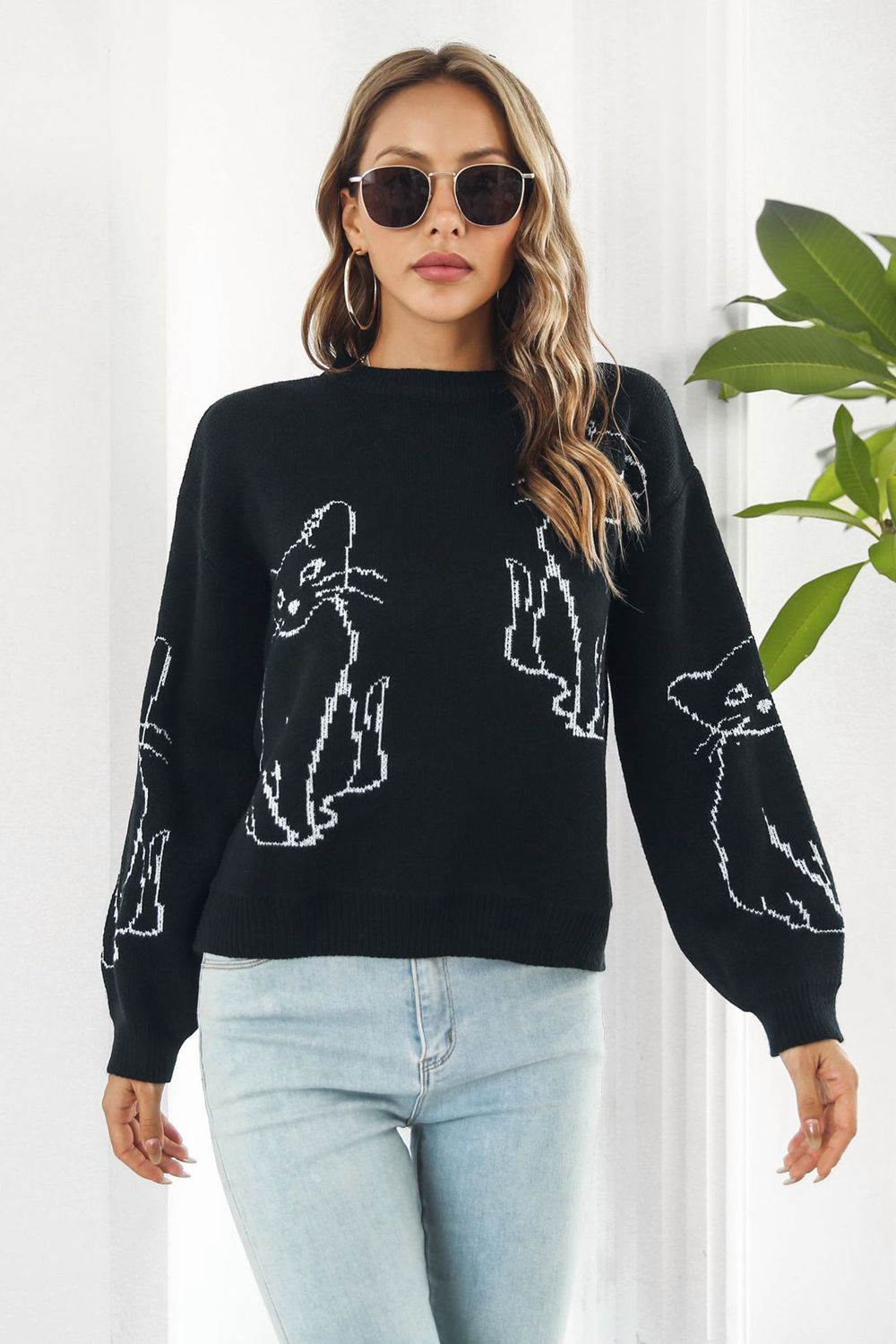 Black acrylic sweater with white cat intarsia knit pattern, crew neck, and long sleeves.