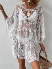 White embroidered crochet kaftan cover-up with bell sleeves and intricate floral details.