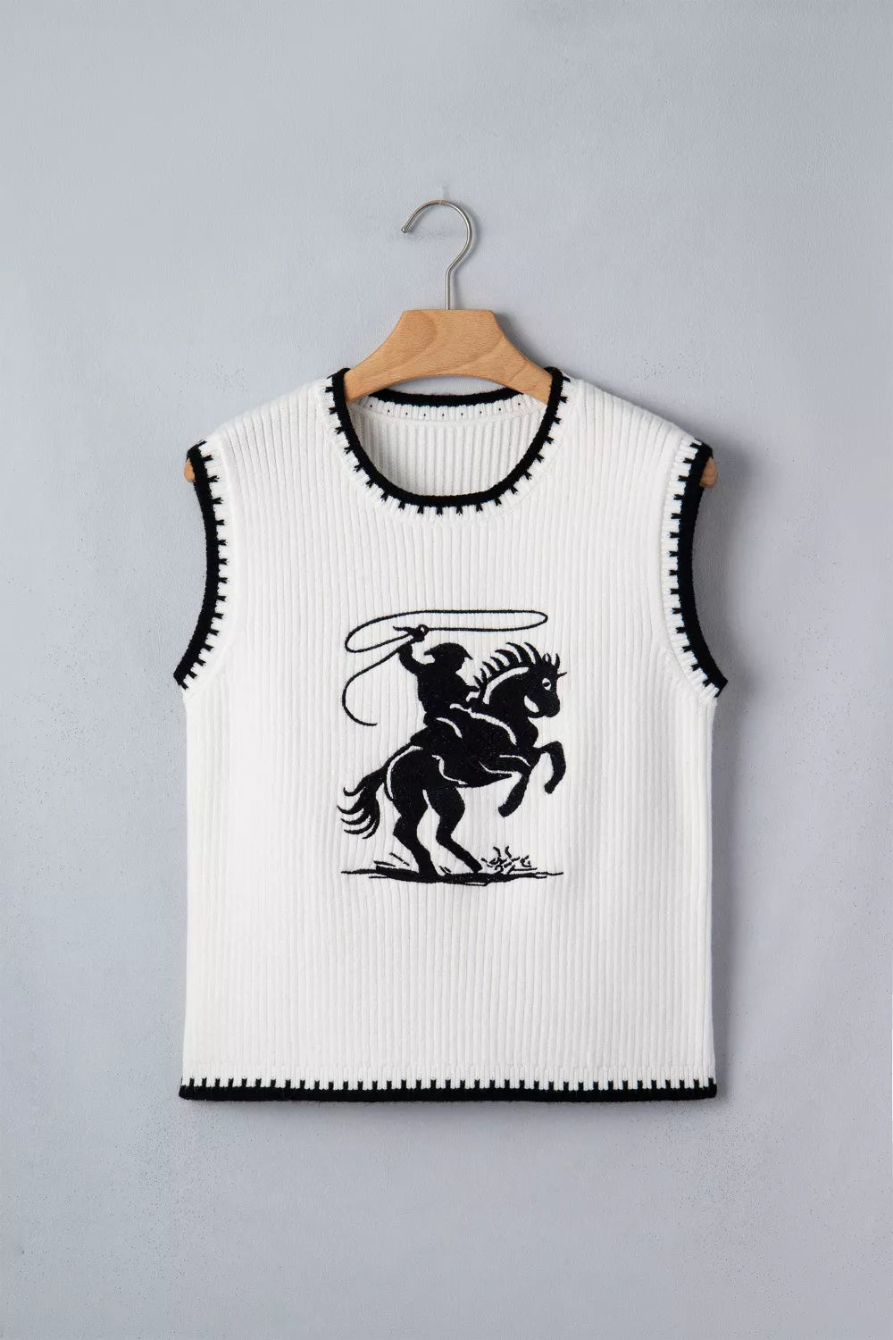 White ribbed sweater vest with black rodeo graphic and contrast trim.
