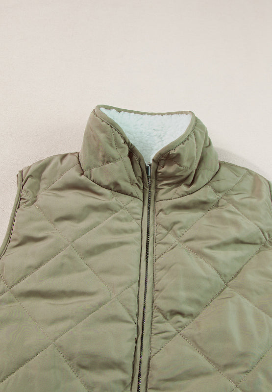 Quilted sherpa-lined utility vest in sage with a stand collar and zip front.