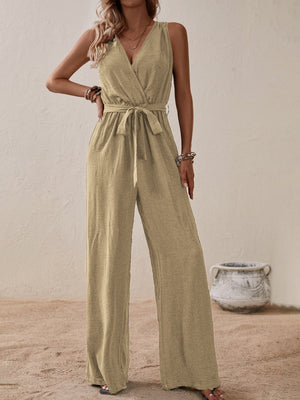 Tan textured wrap-front wide-leg jumpsuit with tie waist and V-neck.