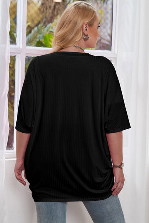 Black ribbed batwing cardigan with short sleeves, draped front detail.