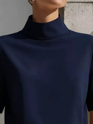 Navy mock neck t-shirt with relaxed sleeves in polyester, shown up close.