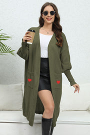 Army green long cardigan with balloon sleeves and red heart pocket details.