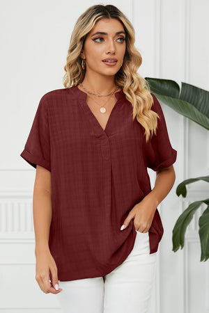 Burgundy linen blend blouse with V-neck, short sleeves, and subtle texture.