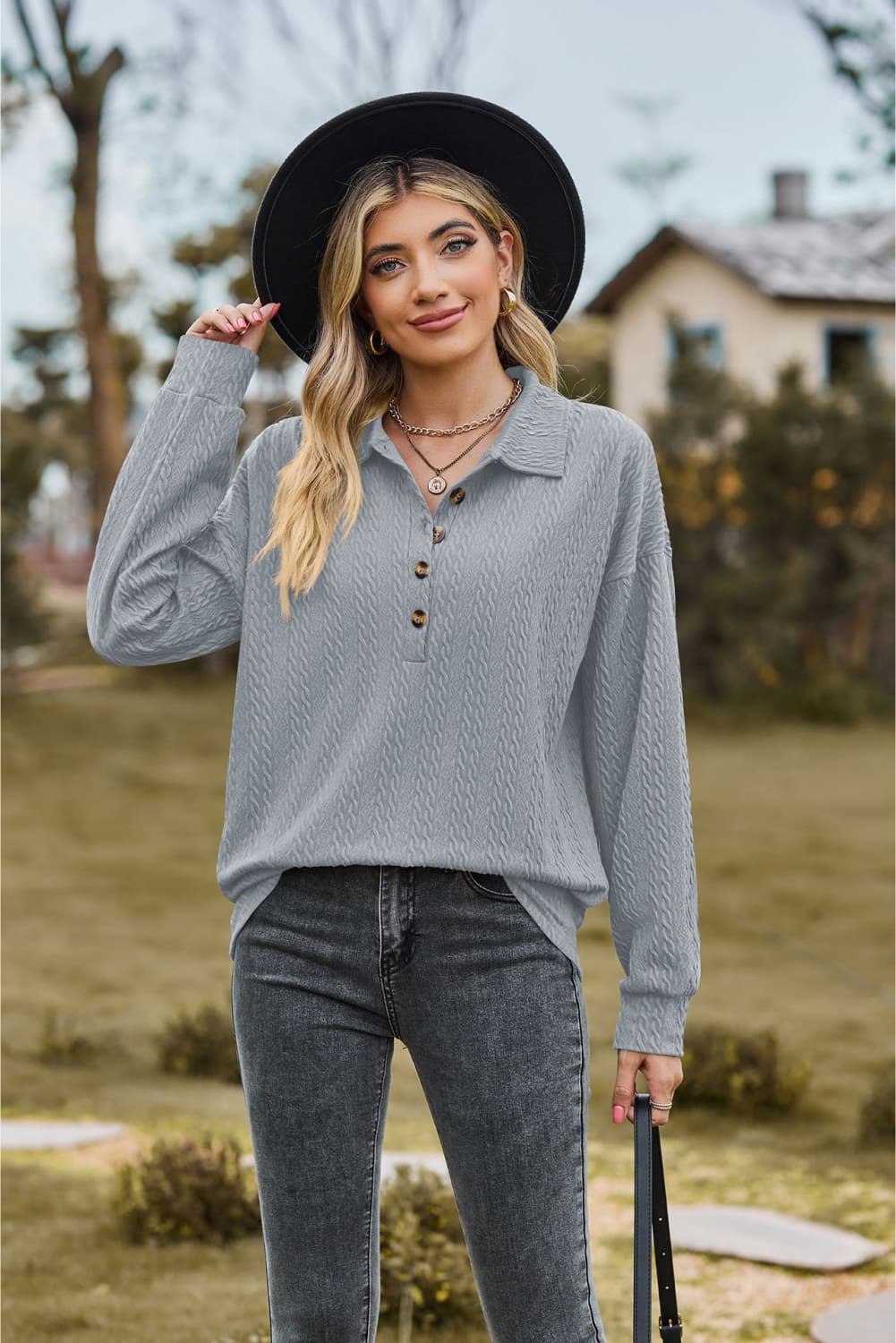 Textured knit polo shirt in light blue with button detail and long sleeves