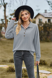 Textured knit polo shirt in light blue with button detail and long sleeves