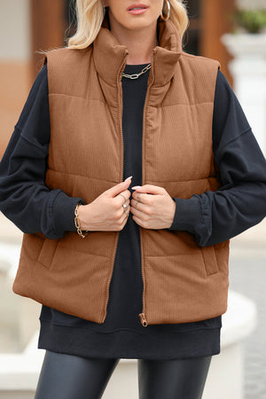 Brown corduroy padded funnel neck vest with zipper closure, worn over a black sweatshirt.