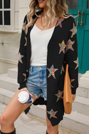 Black knit cardigan with colorful embroidered starbursts, open front, long sleeves, and pockets.