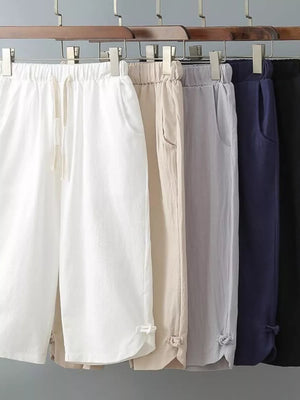Men's cropped sweatpants in white, khaki, grey, navy blue, and black with drawstring waist and cuffed hems.