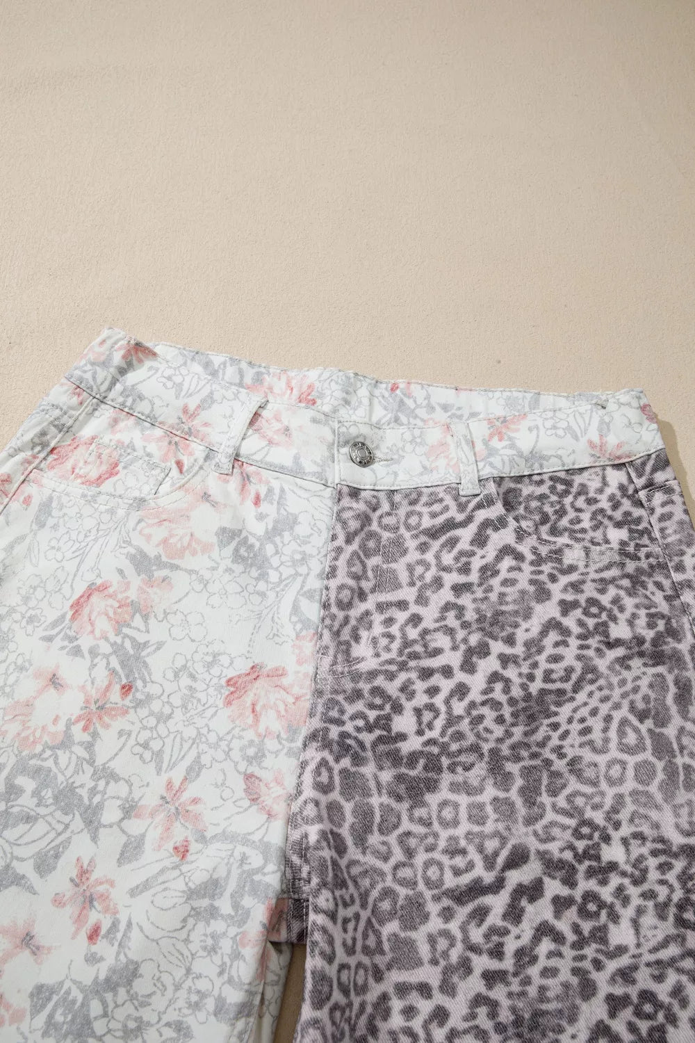 Floral and leopard print wide-leg jeans with a high waist and button closure.