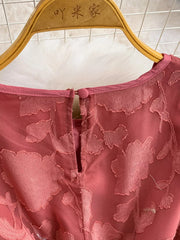 Embroidered tie-waist dress in rust with a floral burnout pattern and button closure.