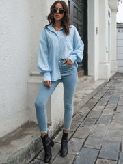Blue poplin blouson sleeve shirt with button front and pockets, styled with jeans.