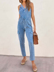 Acid wash cargo jumpsuit with drawstring waist and button-up V-neck in medium blue.