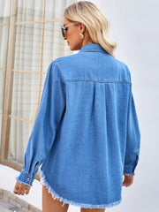 Blue denim shirt with frayed hem and cuffs, featuring a relaxed fit and button closure.