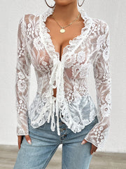 White lace tie-front blouse with ruffles and long sleeves.