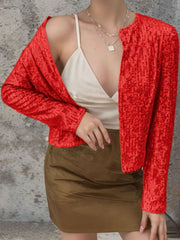 Scarlet sequin bolero jacket with long sleeves and open front, styled with a camisole and skirt.