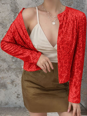 Scarlet sequin bolero jacket with long sleeves and open front, styled with a camisole and skirt.