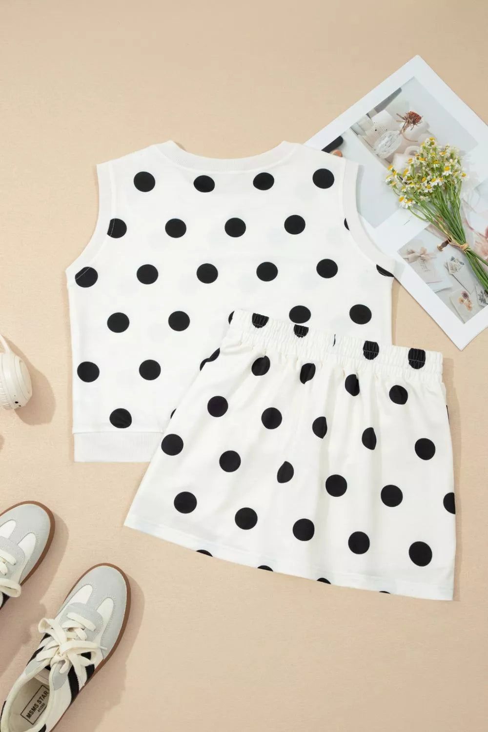 White polka dot ribbed trim two-piece set with sleeveless top and skirt.