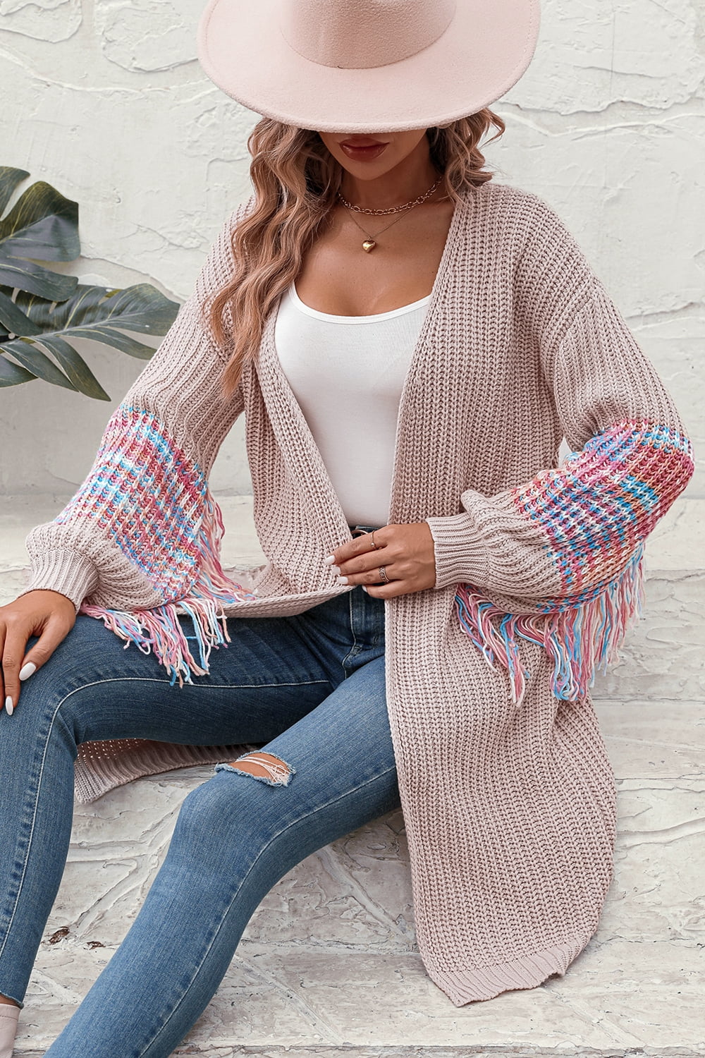 Textured sleeve fringe cardigan in acrylic with colorful plaid detail and fringe trim.