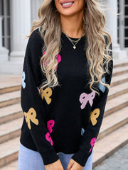 Black knit sweater with colorful bow motif, crew neck, long sleeves.