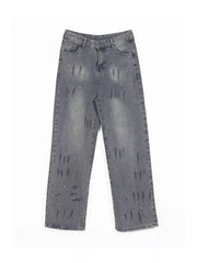 Men's grey wide-leg denim jeans with distressed details and paint splatters.