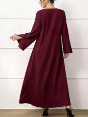 Maxi dress in burgundy with square neck, flare sleeves, and button detail.