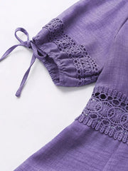 Purple mini dress with lace trim on sleeves and hem, featuring tie details.