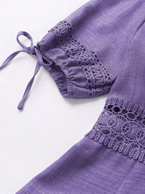 Purple mini dress with lace trim on sleeves and hem, featuring tie details.