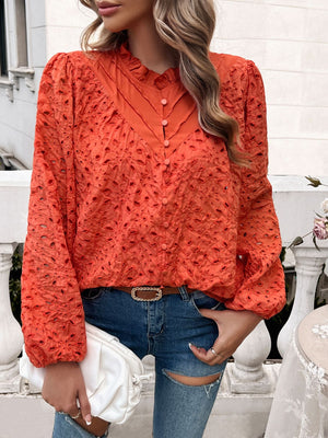 Orange-red eyelet embroidered blouse with ruffle collar and button front.