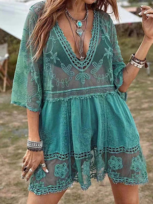Teal lace tiered mini dress with V-neck and bell sleeves, featuring intricate floral embroidery.