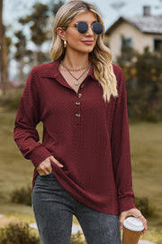 Burgundy textured polo-neck sweater with button detail and long sleeves.