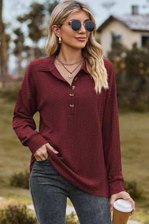 Burgundy textured polo-neck sweater with button detail and long sleeves.