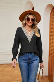 Black eyelet blouse with lace V-neck and ruffle cuffs