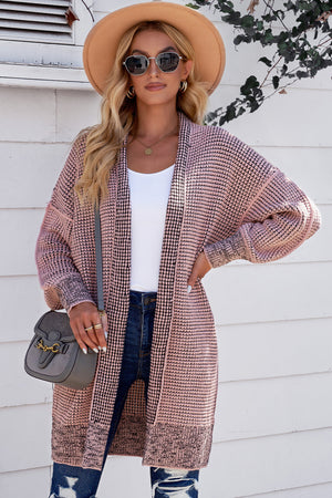 Pink textured puff sleeve open cardigan with a waffle knit pattern and contrast trim.