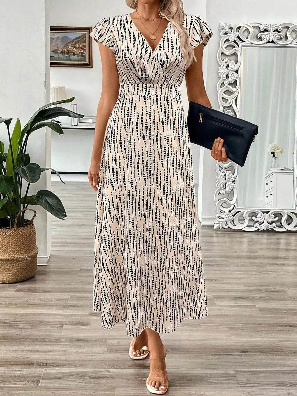 Midi dress with abstract print, V-neck, cap sleeves, and a-line skirt.