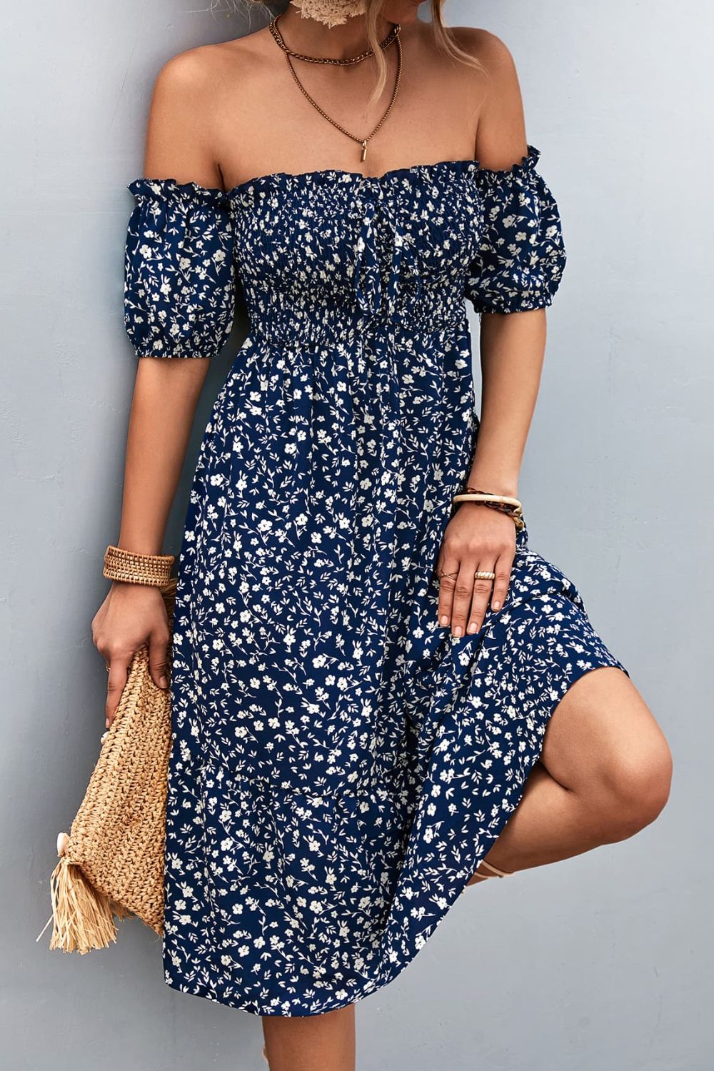 Dark blue floral midi dress with smocked bodice and bubble sleeves.