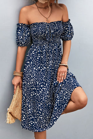 Dark blue floral midi dress with smocked bodice and bubble sleeves.