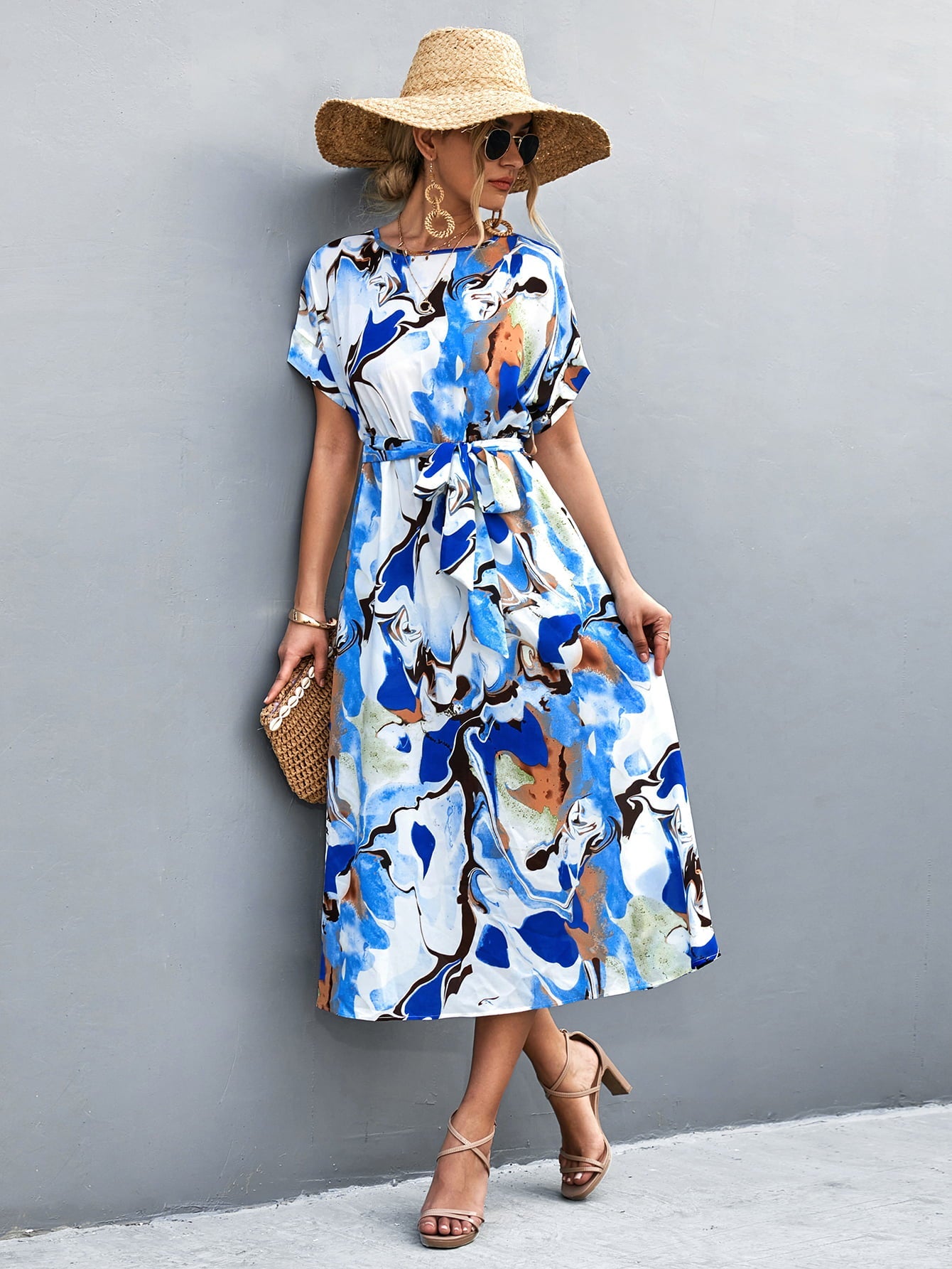 Blue abstract print midi dress with tie waist and short sleeves.