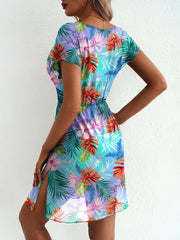 Vibrant leaf print mini dress in sky blue with short sleeves and a high slit.