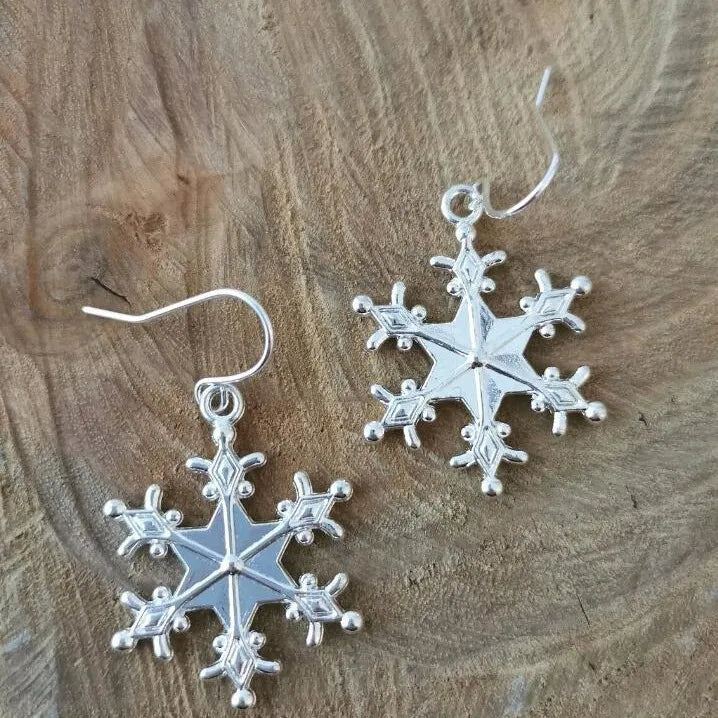 Silver snowflake drop earrings with delicate alloy detail.