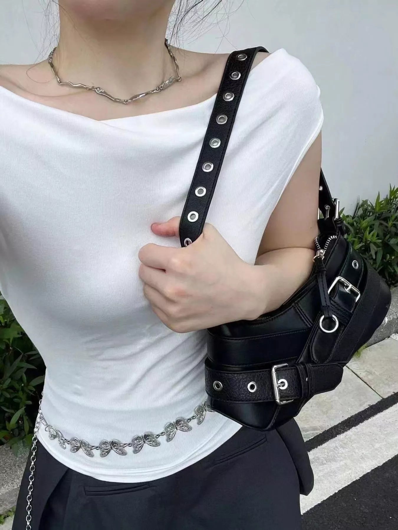Black medium shoulder bag with buckle and grommet strap details