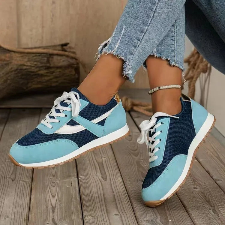Navy and light blue mesh panel runners with white laces and gum soles.