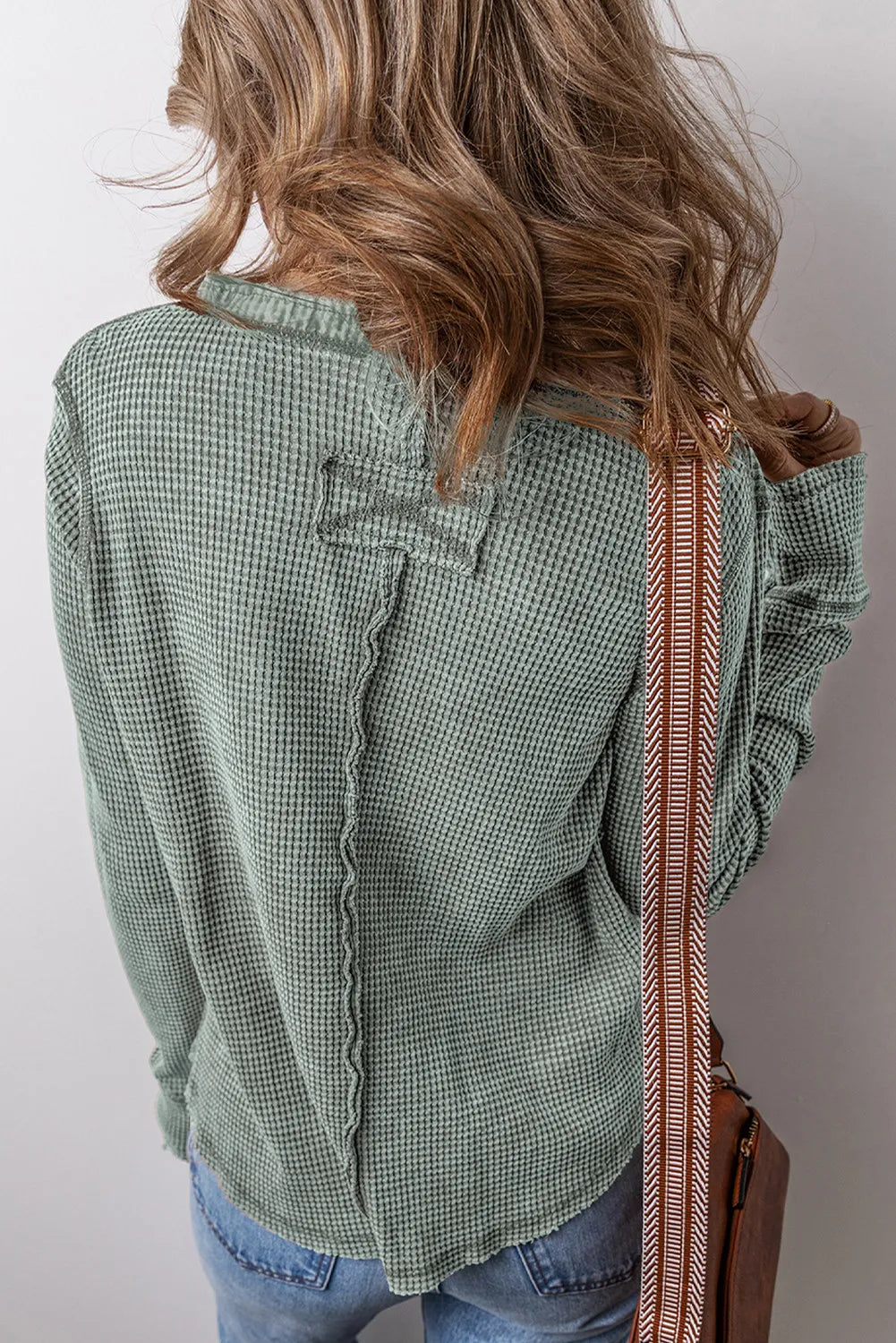 Sage waffle knit long sleeve blouse with contrast stitching detail and decorative back yoke.